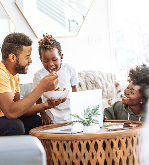 Family smiling and enjoying breakfast together.
