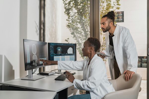 Two doctors conducting research together on computers.